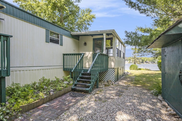 12963 E Englewright Dr, Sand Lake, MI 49343 - view of front of property featuring a water view