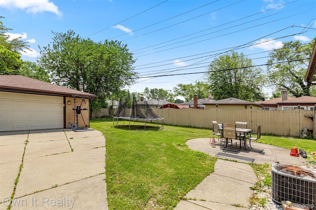 6426 Highview St, Dearborn Heights, MI 48127 - fenced backyard featuring a trampoline, a patio area, and a garage