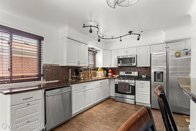 6426 Highview St, Dearborn Heights, MI 48127 - kitchen featuring appliances with stainless steel finishes, white cabinets, backsplash, and dark tile patterned floors