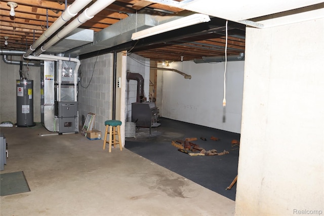 320 Nancy Bird Ln, Clarkston, MI 48371 - unfinished below grade area featuring water heater, heating unit, a wood stove, and a heating unit