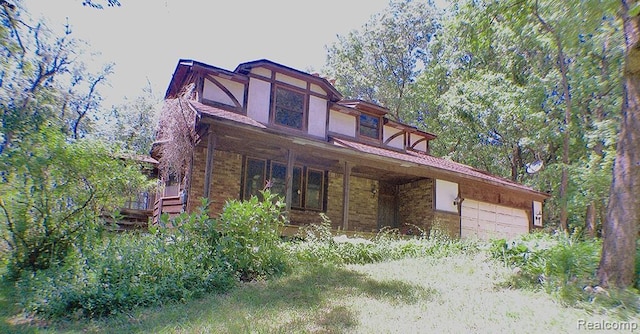 320 Nancy Bird Ln, Clarkston, MI 48371 - tudor home with a porch and a garage
