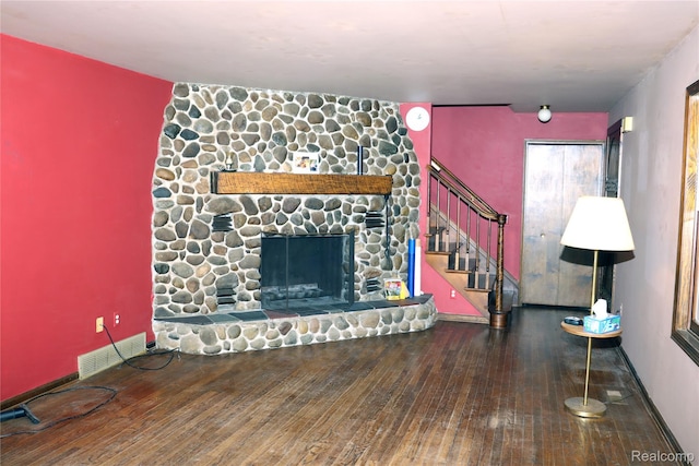 320 Nancy Bird Ln, Clarkston, MI 48371 - unfurnished living room with hardwood / wood-style floors, stairs, and a stone fireplace