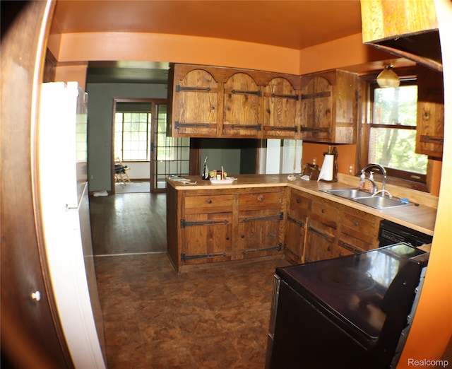 320 Nancy Bird Ln, Clarkston, MI 48371 - kitchen featuring black electric range, brown cabinets, light countertops, and a peninsula