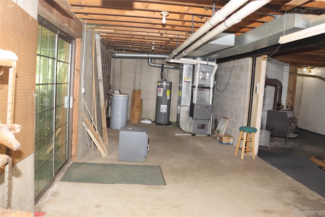 320 Nancy Bird Ln, Clarkston, MI 48371 - below grade area featuring heating unit, electric water heater, a water softener system, and a wood stove