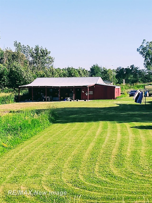 4230 E M-55, Prescott, MI 48756 - view of grassy yard featuring a pole building and view of wooded area