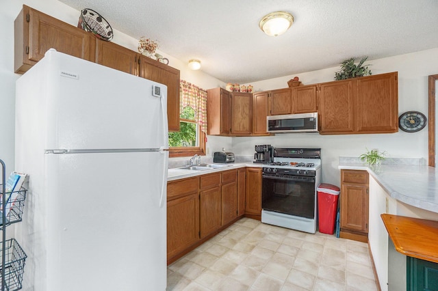 310 W 4th St, Lawton, MI 49065 - kitchen featuring white appliances, light countertops, and brown cabinets
