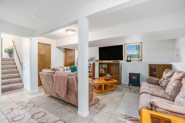 310 W 4th St, Lawton, MI 49065 - living area featuring a wood stove, stairway, and light tile patterned flooring