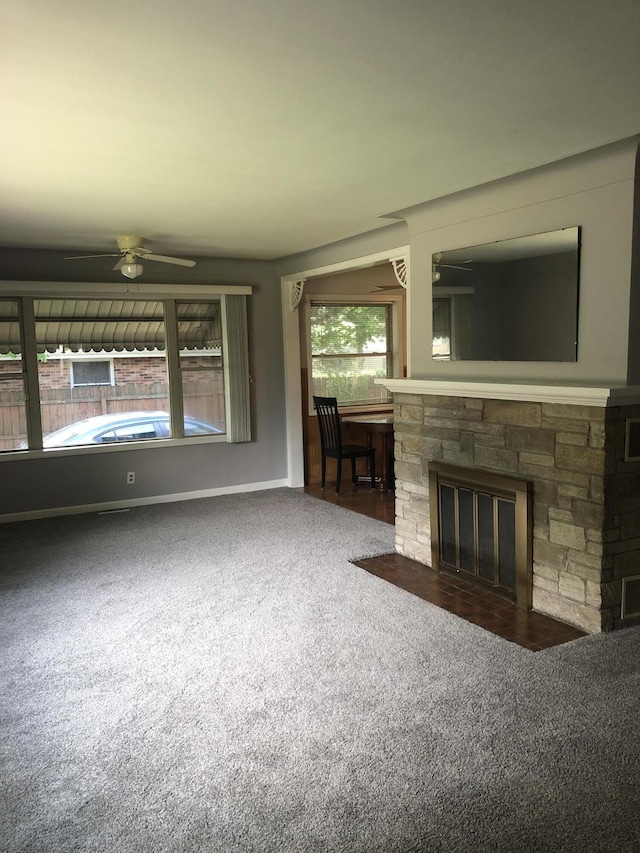 1113 Nichols Rd, Kalamazoo, MI 49006 - unfurnished living room featuring carpet floors, a ceiling fan, and a fireplace