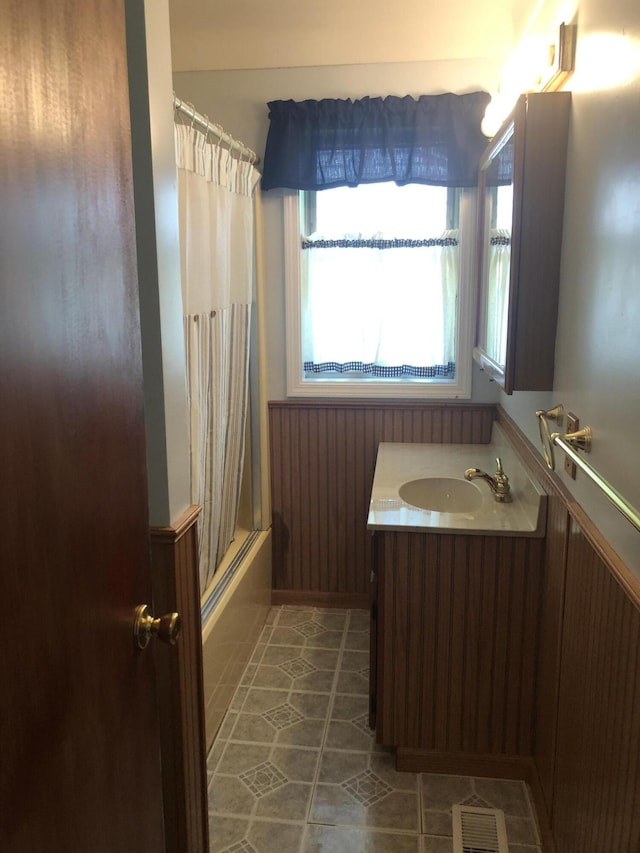 1113 Nichols Rd, Kalamazoo, MI 49006 - bathroom featuring vanity, tile patterned flooring, and shower / bathtub combination with curtain