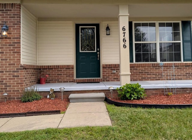 6766 Poplar Dr, Ypsilanti, MI 48197 - doorway to property with brick siding and a porch