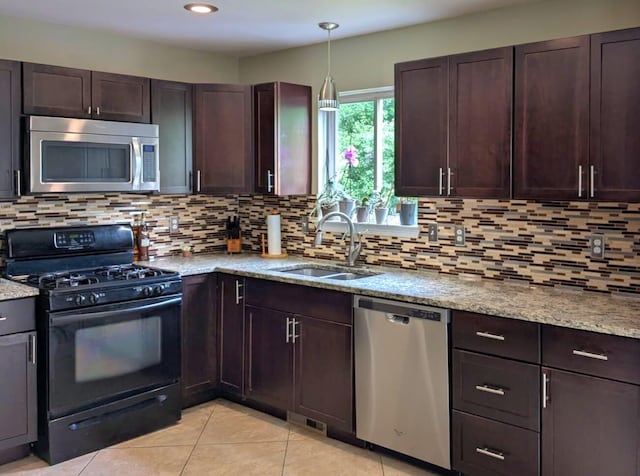 6766 Poplar Dr, Ypsilanti, MI 48197 - kitchen with stainless steel appliances, decorative backsplash, light stone counters, light tile patterned floors, and recessed lighting