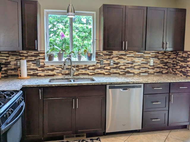 6766 Poplar Dr, Ypsilanti, MI 48197 - kitchen featuring dishwasher, black gas stove, dark brown cabinetry, and light stone counters