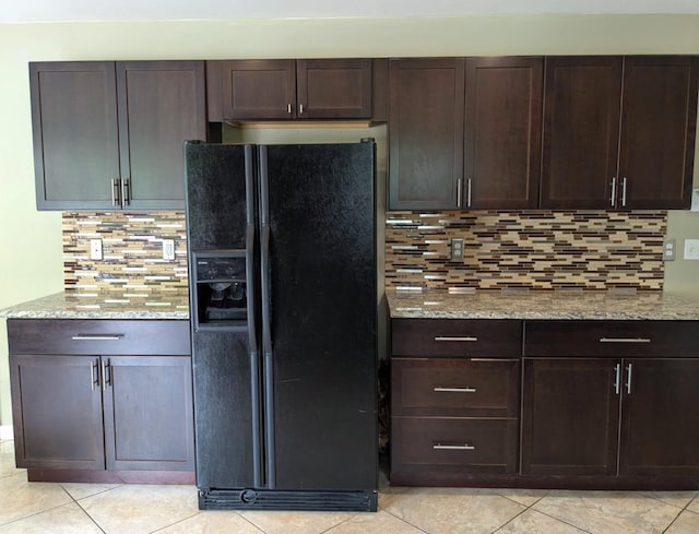 6766 Poplar Dr, Ypsilanti, MI 48197 - kitchen with black fridge with ice dispenser, light tile patterned flooring, dark brown cabinetry, and decorative backsplash