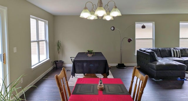 6766 Poplar Dr, Ypsilanti, MI 48197 - dining area with a chandelier and dark wood-style floors