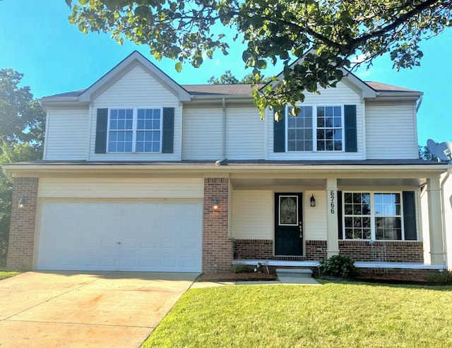 6766 Poplar Dr, Ypsilanti, MI 48197 - traditional-style home with brick siding, an attached garage, a front yard, a porch, and driveway