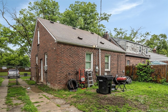 11358 Asbury Park, Detroit, MI 48205 - rear view of house featuring brick siding, roof with shingles, a gate, and a chimney