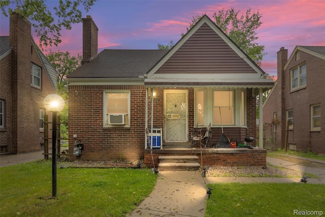 11358 Asbury Park, Detroit, MI 48205 - bungalow-style home featuring a porch, a chimney, brick siding, a front lawn, and cooling unit