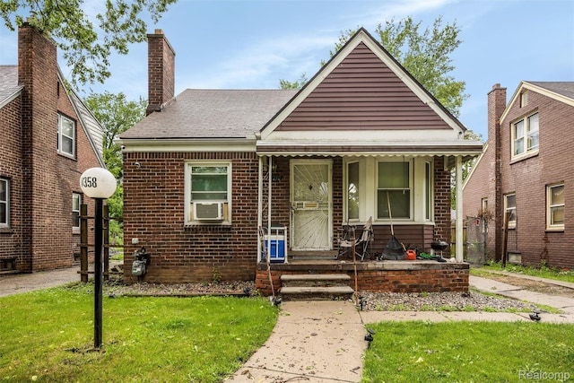 11358 Asbury Park, Detroit, MI 48205 - view of front of property featuring a front lawn, covered porch, a chimney, cooling unit, and brick siding