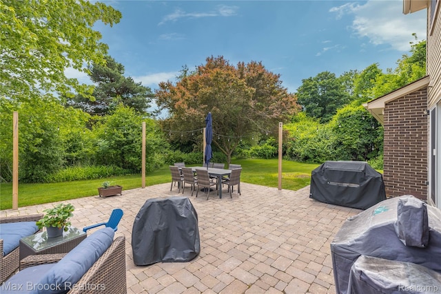 6247 Carpathian Ct, West Bloomfield, MI 48324 - view of patio / terrace featuring area for grilling, outdoor dining space, view of wooded area, and an outdoor hangout area