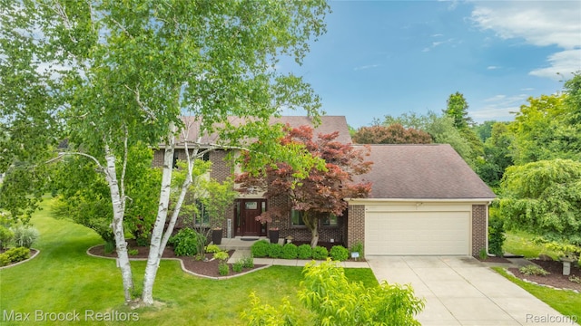 6247 Carpathian Ct, West Bloomfield, MI 48324 - view of property hidden behind natural elements featuring a garage, driveway, brick siding, a front lawn, and a shingled roof