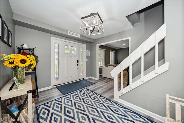 6247 Carpathian Ct, West Bloomfield, MI 48324 - foyer entrance with wood finished floors and a chandelier