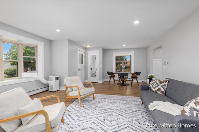 630 Westview Ave NW, Grand Rapids, MI 49504 - living room featuring a baseboard radiator, recessed lighting, and wood finished floors