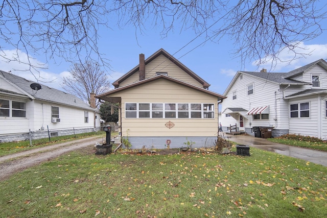317 E Argyle St, Jackson, MI 49202 - view of front of home featuring a chimney, cooling unit, and driveway