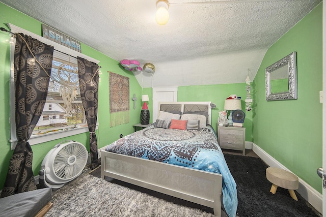 317 E Argyle St, Jackson, MI 49202 - carpeted bedroom with a textured ceiling and baseboards