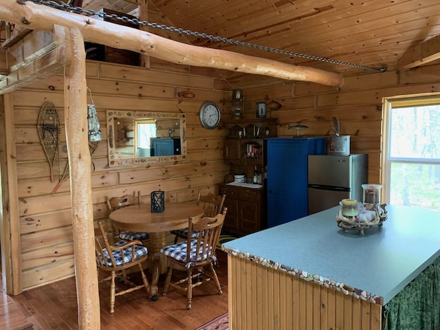 5093 E County Line Rd, Michigan, MI 49411 - dining room with light wood finished floors, vaulted ceiling, and wooden walls