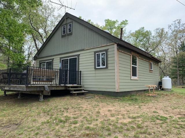 5093 E County Line Rd, Michigan, MI 49411 - rear view of house featuring a wooden deck and a lawn