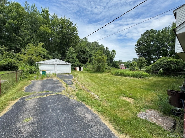 35740 Beverly Rd, Detroit, MI 48174 - view of yard with a detached garage and an outdoor structure