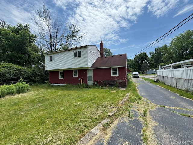 35740 Beverly Rd, Detroit, MI 48174 - view of front facade featuring asphalt driveway and a chimney