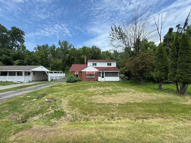 35740 Beverly Rd, Detroit, MI 48174 - view of front of property featuring a chimney, driveway, and a front lawn