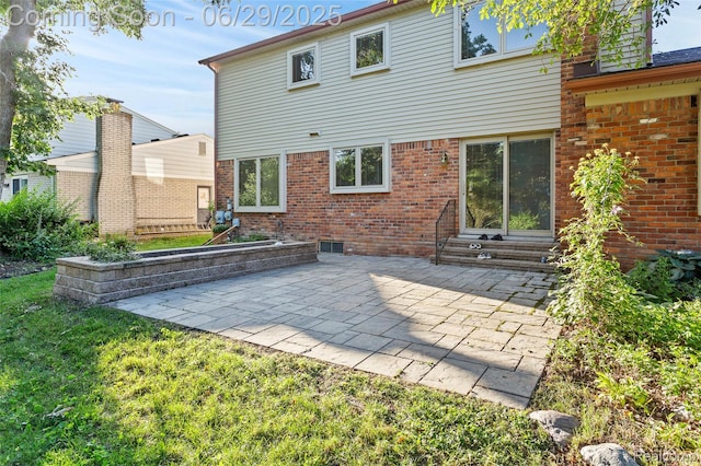 1304 Player Dr, Troy, MI 48085 - back of house featuring entry steps, a patio area, brick siding, and a yard