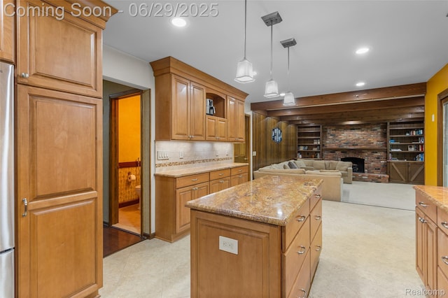 1304 Player Dr, Troy, MI 48085 - kitchen featuring a brick fireplace, recessed lighting, open floor plan, light stone counters, and a center island