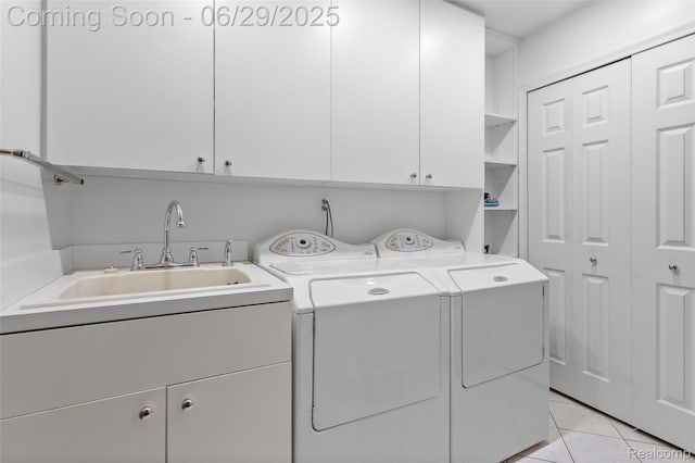 1304 Player Dr, Troy, MI 48085 - laundry area featuring cabinet space, washer and clothes dryer, and light tile patterned flooring
