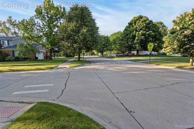 1304 Player Dr, Troy, MI 48085 - view of concrete street featuring traffic signs and sidewalks