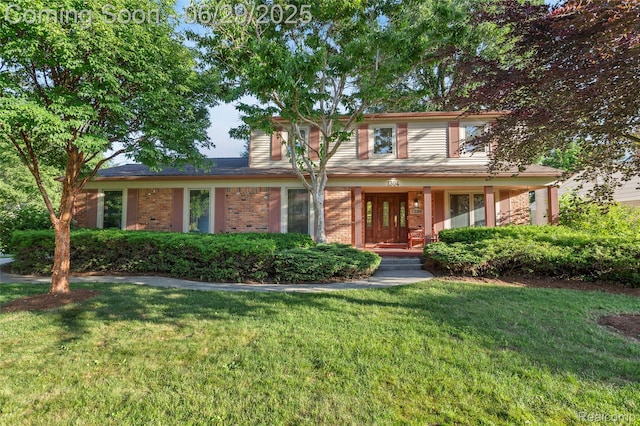 1304 Player Dr, Troy, MI 48085 - traditional home with a front lawn, a porch, and brick siding