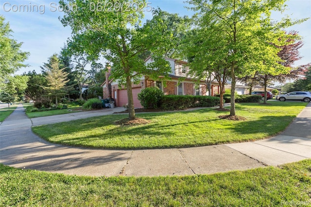 1304 Player Dr, Troy, MI 48085 - view of front of house featuring a front yard, brick siding, a garage, and concrete driveway