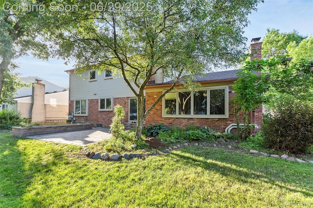 1304 Player Dr, Troy, MI 48085 - rear view of property with brick siding, a lawn, a patio, and a chimney