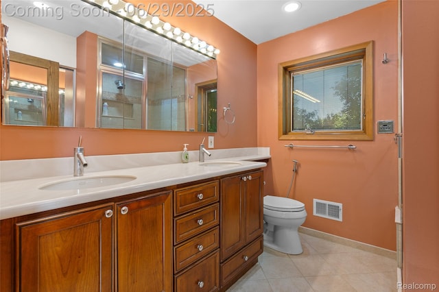 1304 Player Dr, Troy, MI 48085 - bathroom featuring double vanity, tile patterned floors, and a shower with shower door