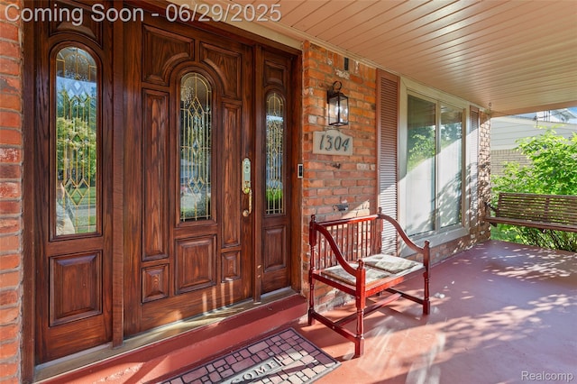 1304 Player Dr, Troy, MI 48085 - view of exterior entry featuring a porch and brick siding