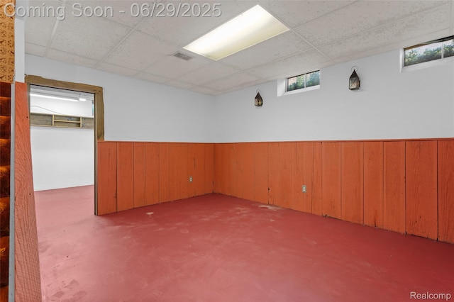 1304 Player Dr, Troy, MI 48085 - empty room with a drop ceiling, wainscoting, and wooden walls