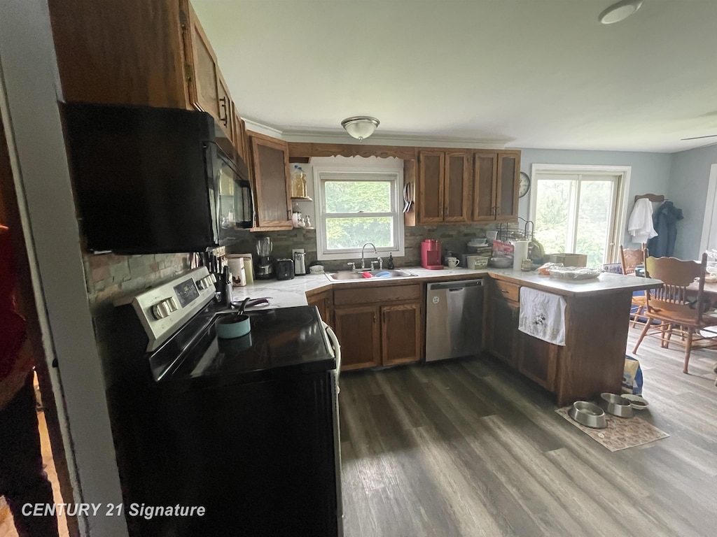 11469 Duffield Rd, Montrose, MI 48457 - kitchen with black appliances, backsplash, light countertops, and brown cabinetry