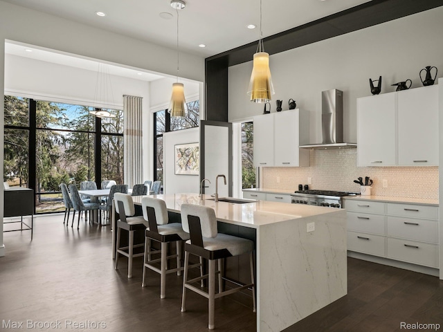 4890 Charing Cross Rd, Bloomfield Hills, MI 48304 - kitchen with wall chimney range hood, decorative light fixtures, white cabinets, tasteful backsplash, and recessed lighting