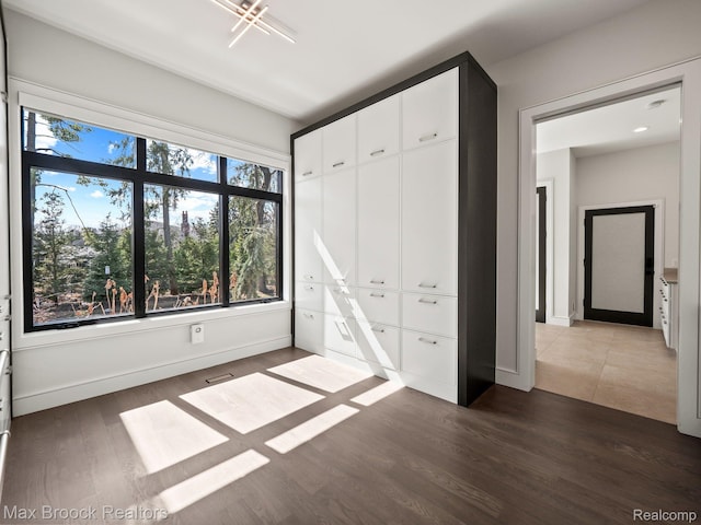 4890 Charing Cross Rd, Bloomfield Hills, MI 48304 - unfurnished bedroom with dark wood-style floors and a closet