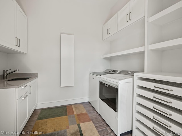 4890 Charing Cross Rd, Bloomfield Hills, MI 48304 - laundry area featuring washer and clothes dryer, dark wood-style floors, and cabinet space