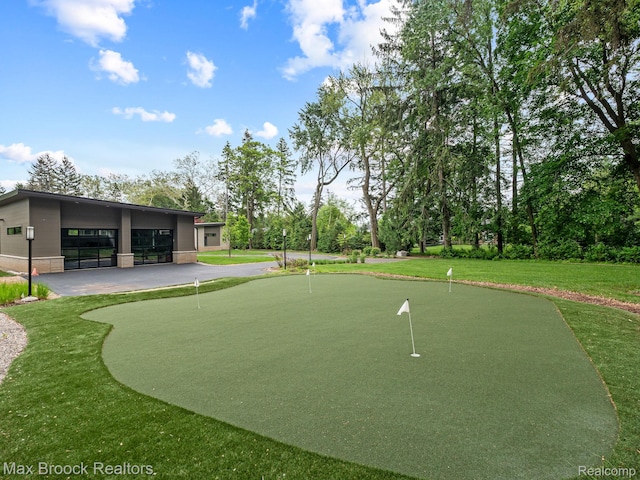 4890 Charing Cross Rd, Bloomfield Hills, MI 48304 - surrounding community with an area to practice putting, a yard, and view of scattered trees