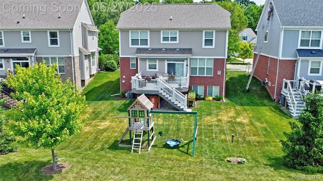 28545 Cottage Ln, New Hudson, MI 48165 - back of house with a playground, a wooden deck, a lawn, brick siding, and stairway