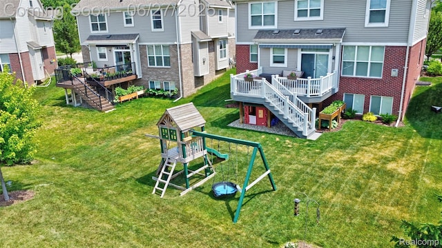 28545 Cottage Ln, New Hudson, MI 48165 - back of property featuring stairway, a deck, brick siding, and a yard